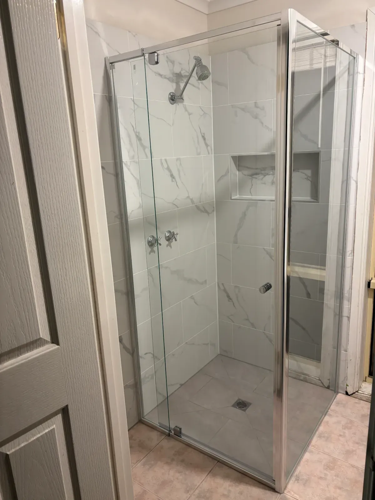 shower replacement: new marble-look walls, niche and framed glass