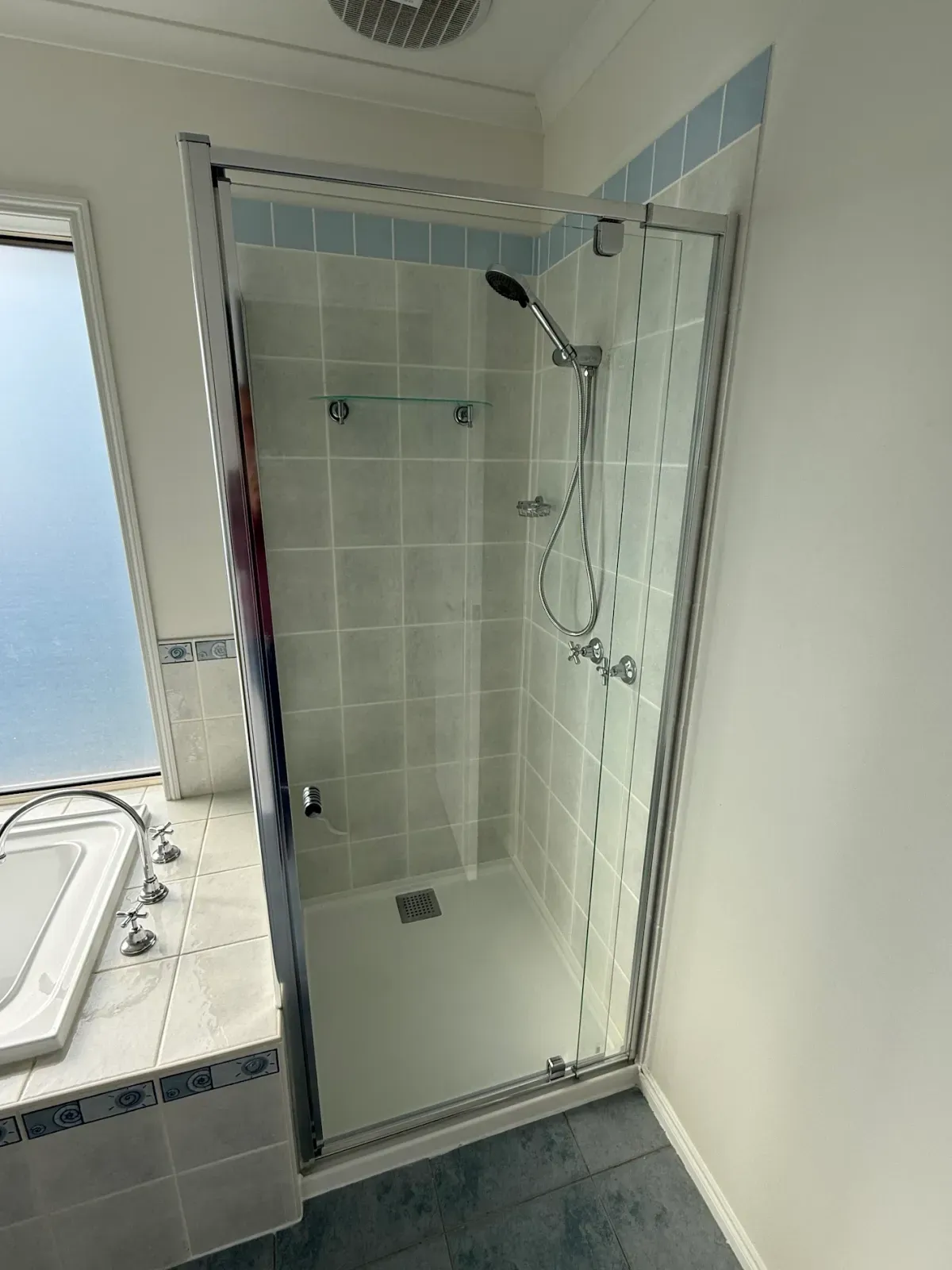 the finished shower with new glass and handheld
